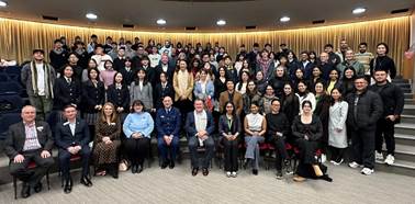 A group of people posing for a photo
Description automatically generated