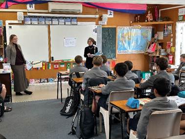 A teacher teaching a class
Description automatically generated